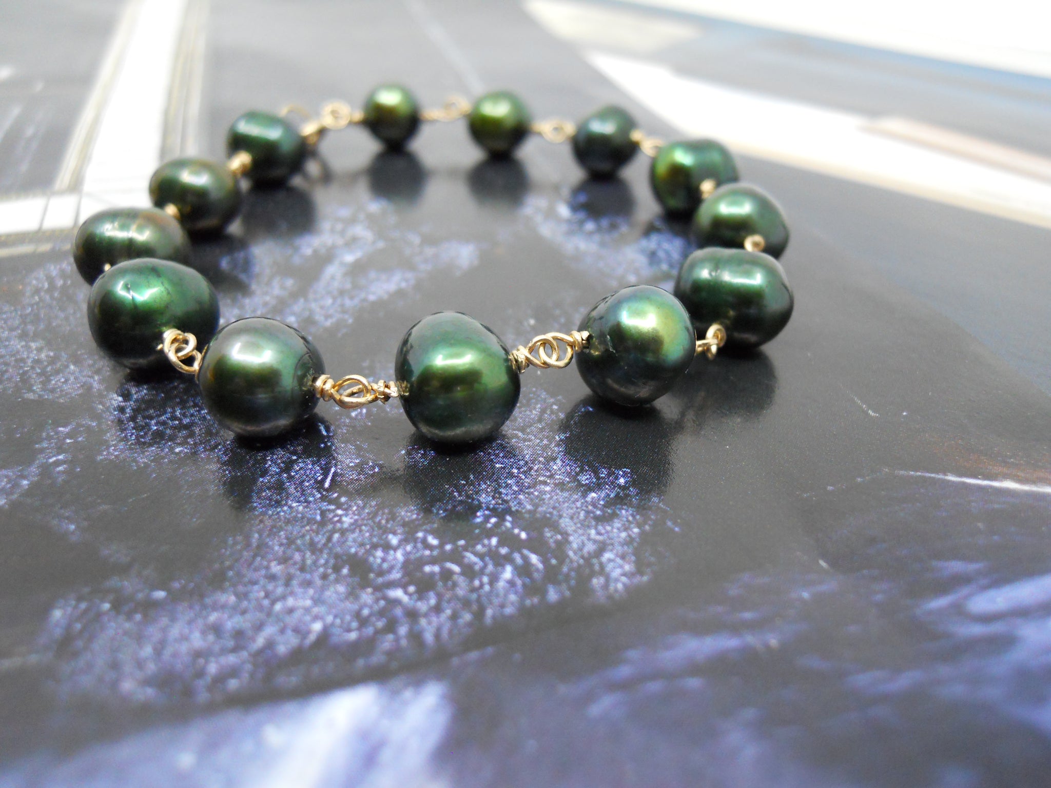 Guldarmbånd med flaske grønne perler